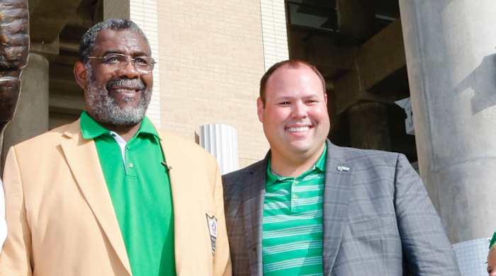 North Texas Athletic Director Wren Baker (right) at the school’s statue unveiling for Hall of Famer “Mean” Joe Greene.
